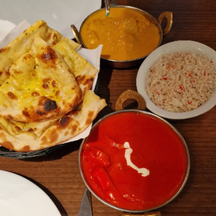  two pots of curries and a plate of rice with bread served at Kathmandu Restaurant Glasgow 