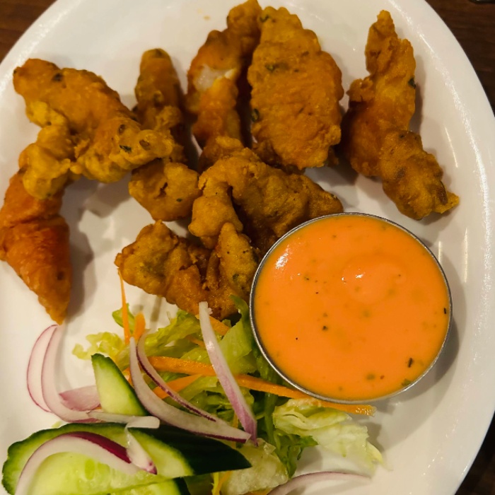  pakoras with salad and sauce on a plate served at Kathmandu Restaurant Glasgow 