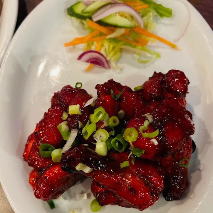  Nepalese Chilli Chicken with salad on a plate at Kathmandu Restaurant Glasgow 