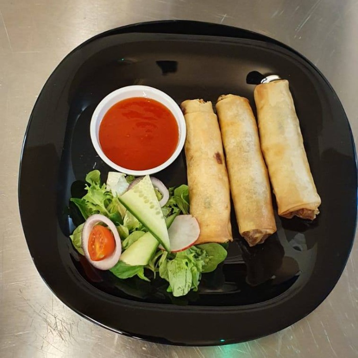  3 wraps with salad and sauce on a plate served at Kathmandu Restaurant Glasgow 